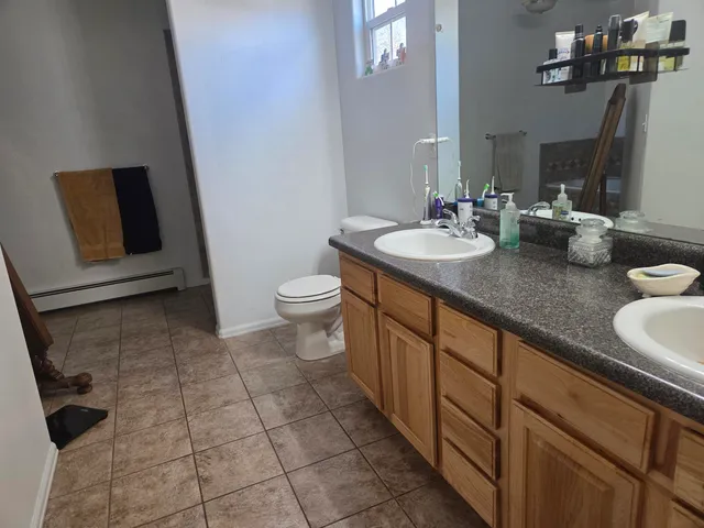 a bathroom with a sink a toilet and mirror