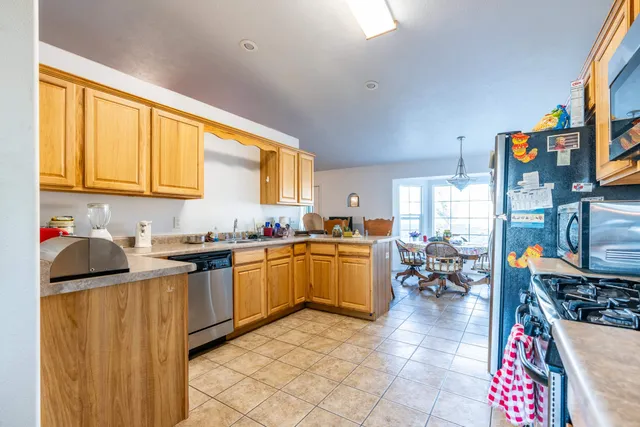 a kitchen with granite countertop a sink stove and cabinets