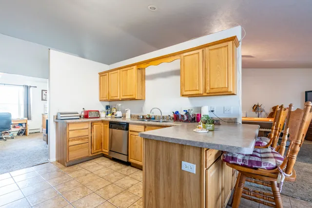 a kitchen with a sink cabinets and wooden floor