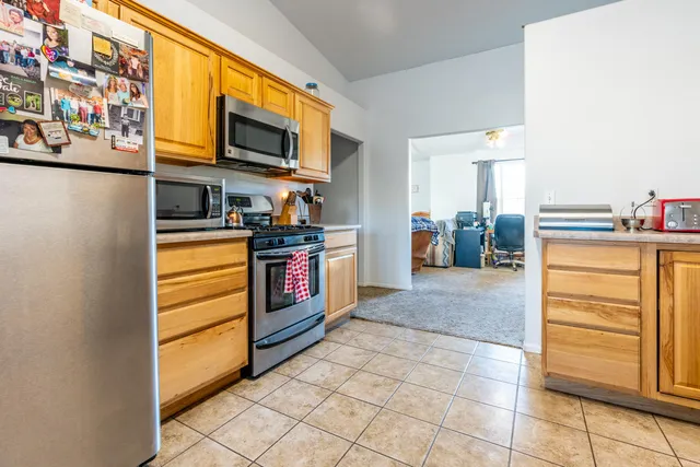 a kitchen with stainless steel appliances granite countertop a stove and a refrigerator
