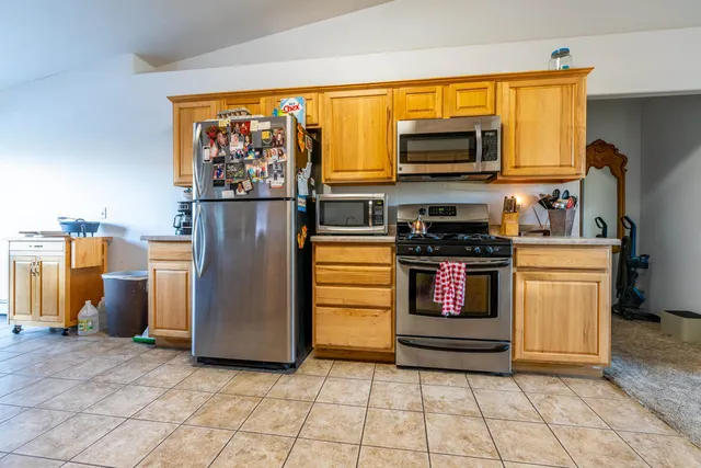 a kitchen with stainless steel appliances a stove and a refrigerator