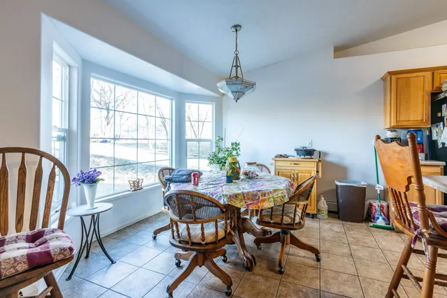 a view of a dining room with furniture and a chandelier