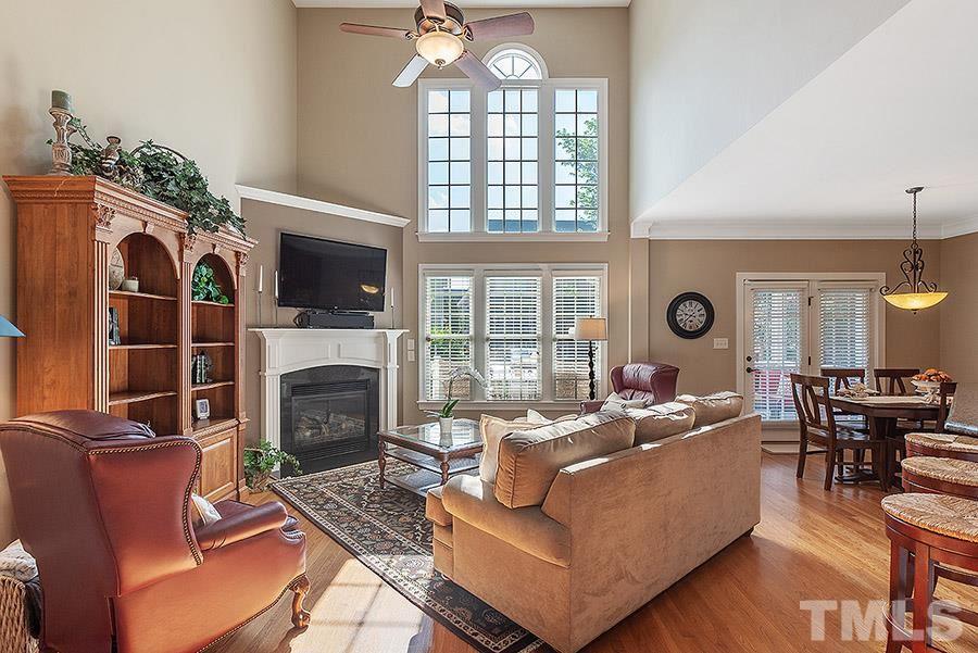 117 Bancroft Brook Drive Cary, NC 27519 - Photo 11 of 29 a living room with furniture a fireplace and a large window