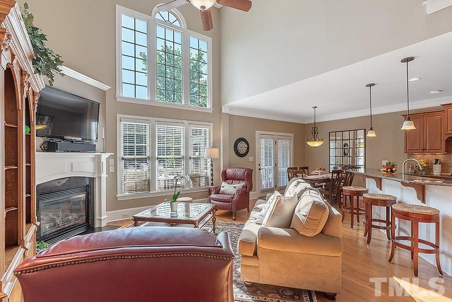 117 Bancroft Brook Drive Cary, NC 27519 - Photo 12 of 29 a living room with furniture a fireplace and a flat screen tv