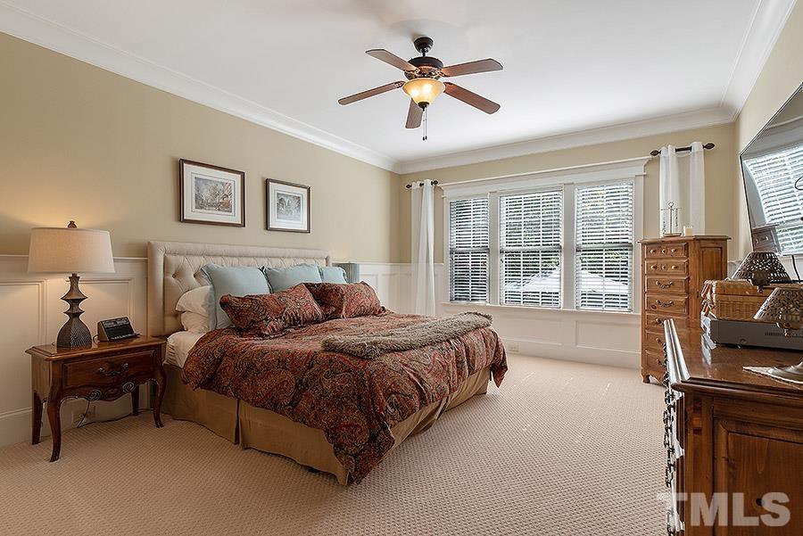 117 Bancroft Brook Drive Cary, NC 27519 - Photo 15 of 29 a bedroom with a bed and a chandelier