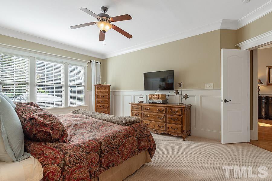 117 Bancroft Brook Drive Cary, NC 27519 - Photo 16 of 29 a bedroom with a bed and a flat screen tv