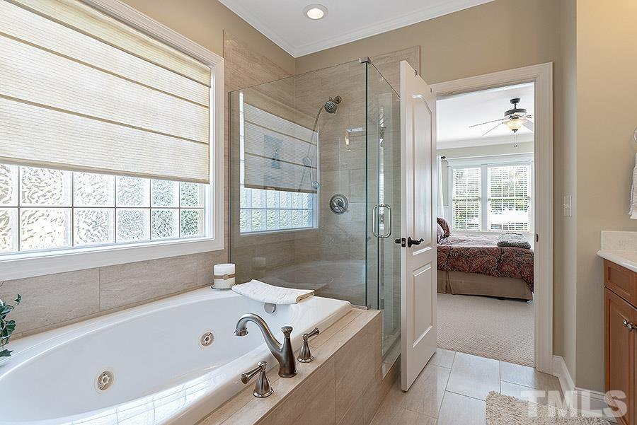 117 Bancroft Brook Drive Cary, NC 27519 - Photo 18 of 29 a bathroom with a tub and a large window