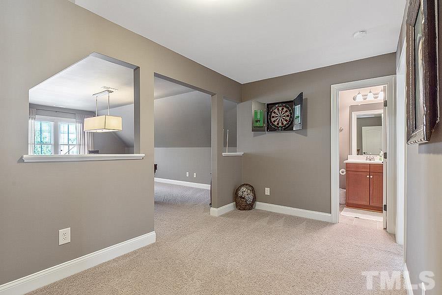 117 Bancroft Brook Drive Cary, NC 27519 - Photo 19 of 29 an empty room with a chair and mirror