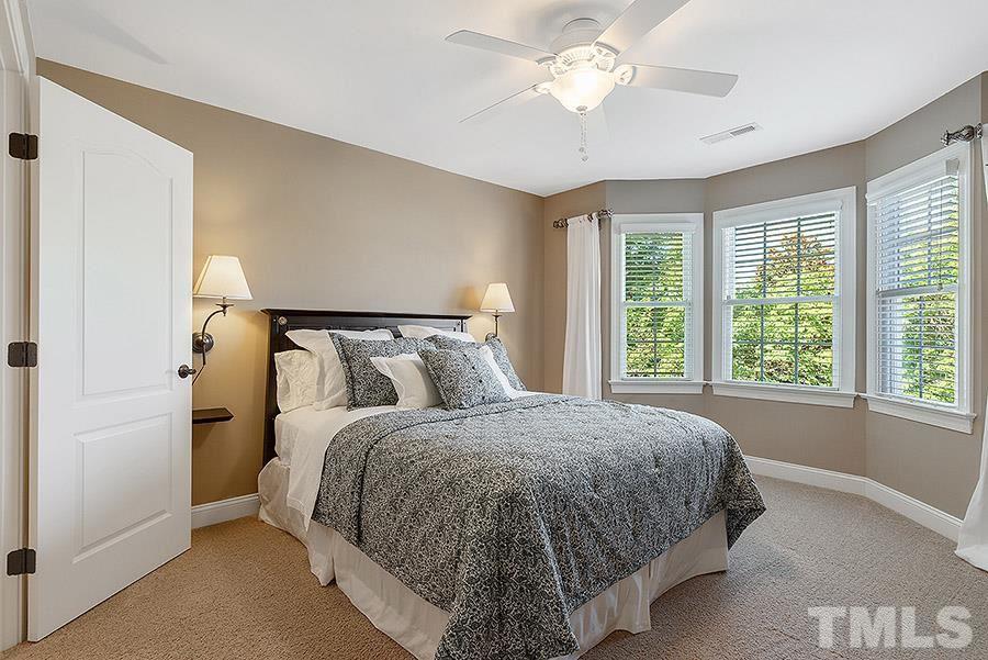 117 Bancroft Brook Drive Cary, NC 27519 - Photo 23 of 29 a bed sitting in a bedroom next to a window