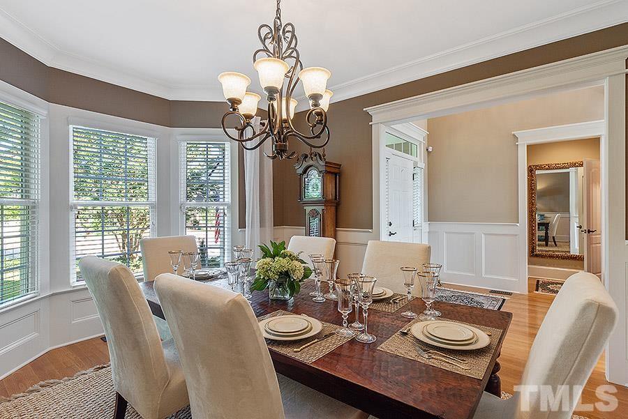 117 Bancroft Brook Drive Cary, NC 27519 - Photo 4 of 29 a dining room with furniture a chandelier and wooden floor