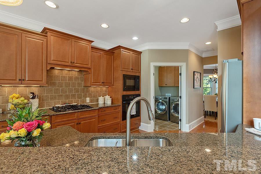 117 Bancroft Brook Drive Cary, NC 27519 - Photo 7 of 29 a kitchen with stainless steel appliances granite countertop a sink and cabinets