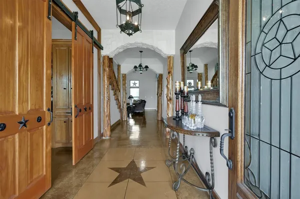 a view of a hallway with dining area and glass door
