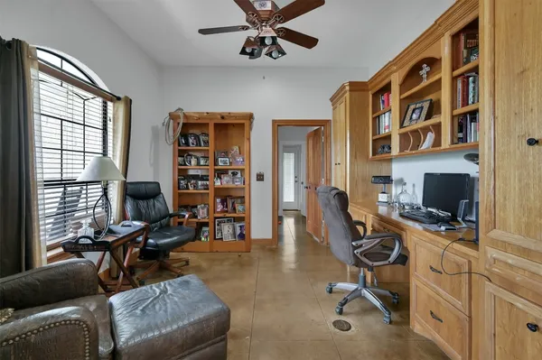 a view of a livingroom with workspace and a window