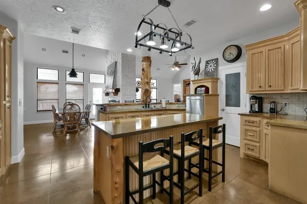 a large kitchen with a table and chairs
