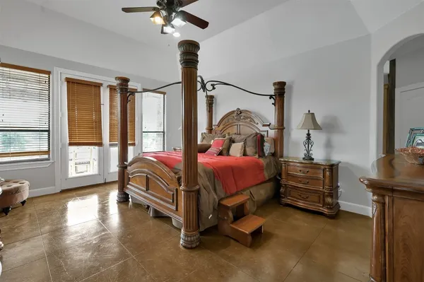 a bedroom with a bed chair and window