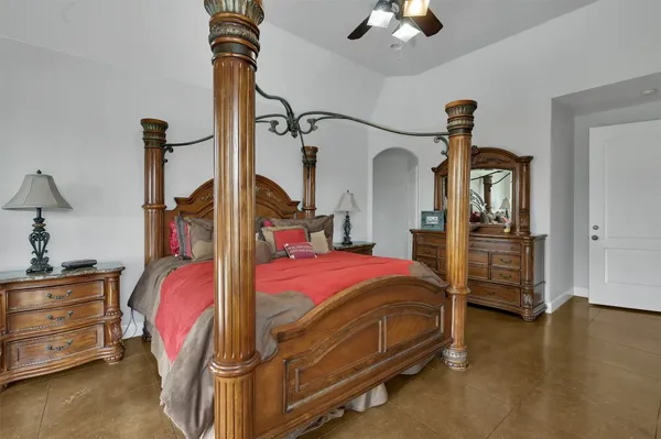 a bedroom with bed and a chandelier