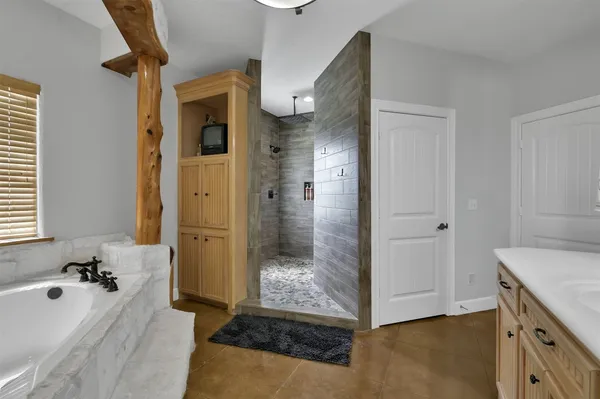 a bathroom with a tub shower and sink