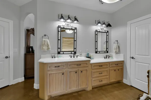 a bathroom with double sink and a mirror