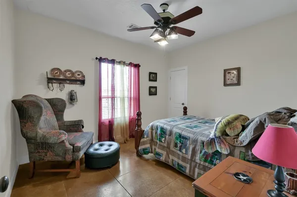 a bedroom with furniture and a window