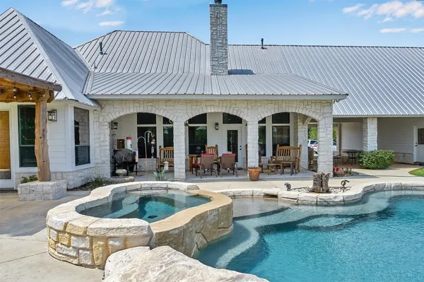 a view of a dinning room and swimming pool