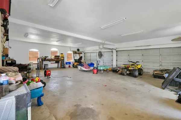 a view of a garage with cars and other equipment