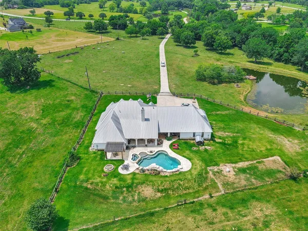 an aerial view of a house with outdoor space and street view