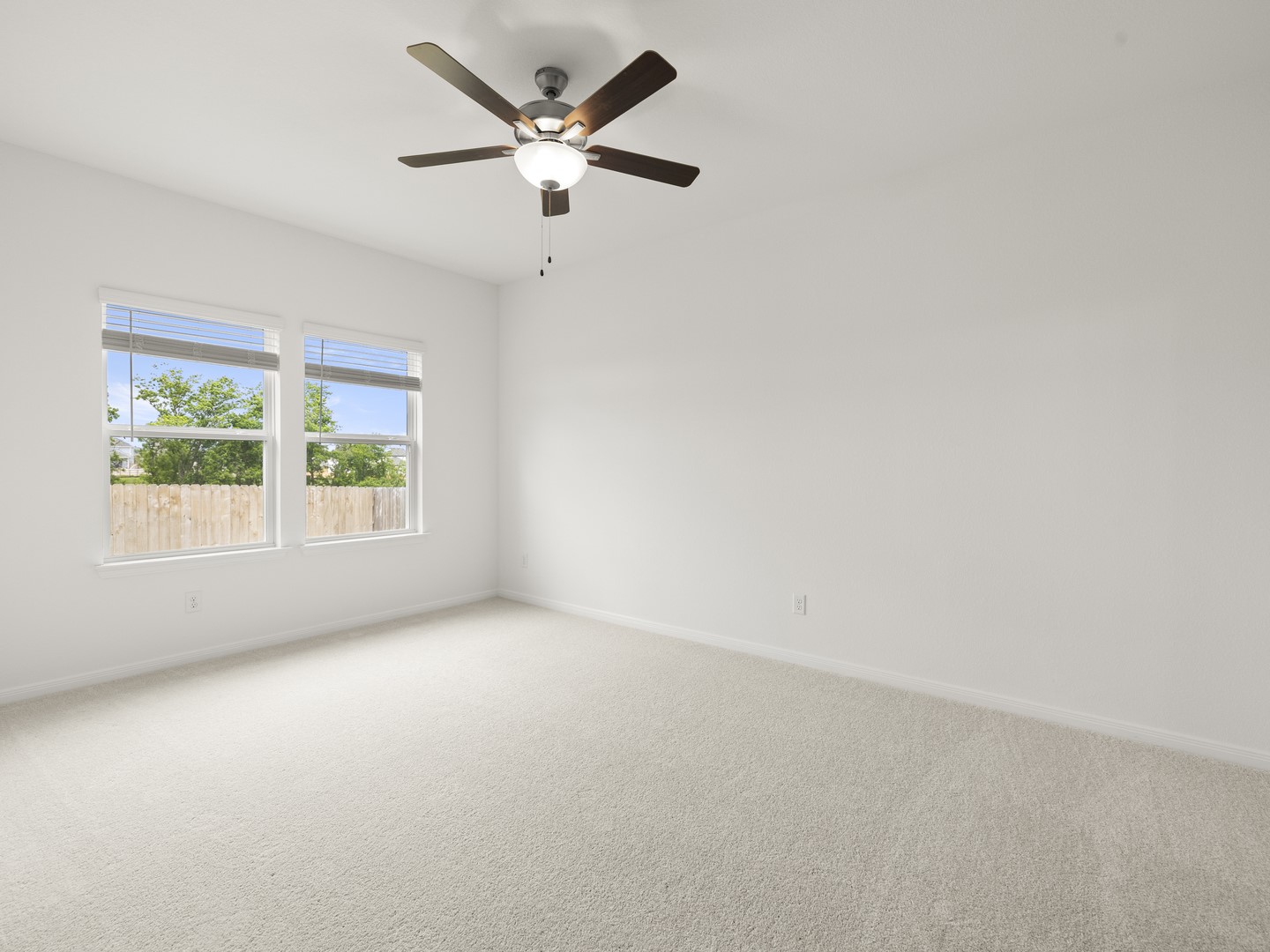 513 Yellow Ribbon Trail Jarrell, TX 76537 - Photo 10 of 23 Well-lit and tranquil, this bedroom provides a comfortable retreat with a cooling ceiling fan.