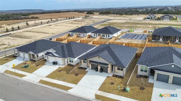 an aerial view of residential houses with outdoor space