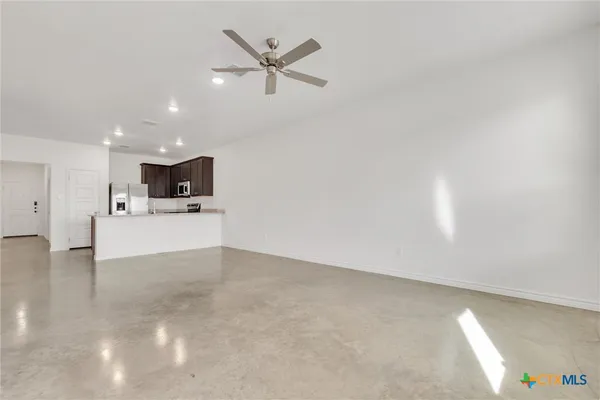 a view of a livingroom with a kitchen island a sink and dishwasher