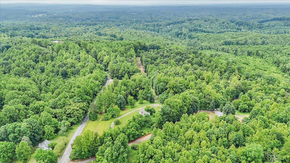 38 Frank Redd Road Fieldale, VA 24089 - Photo 6 of 12 an aerial view of a house with a lush green forest