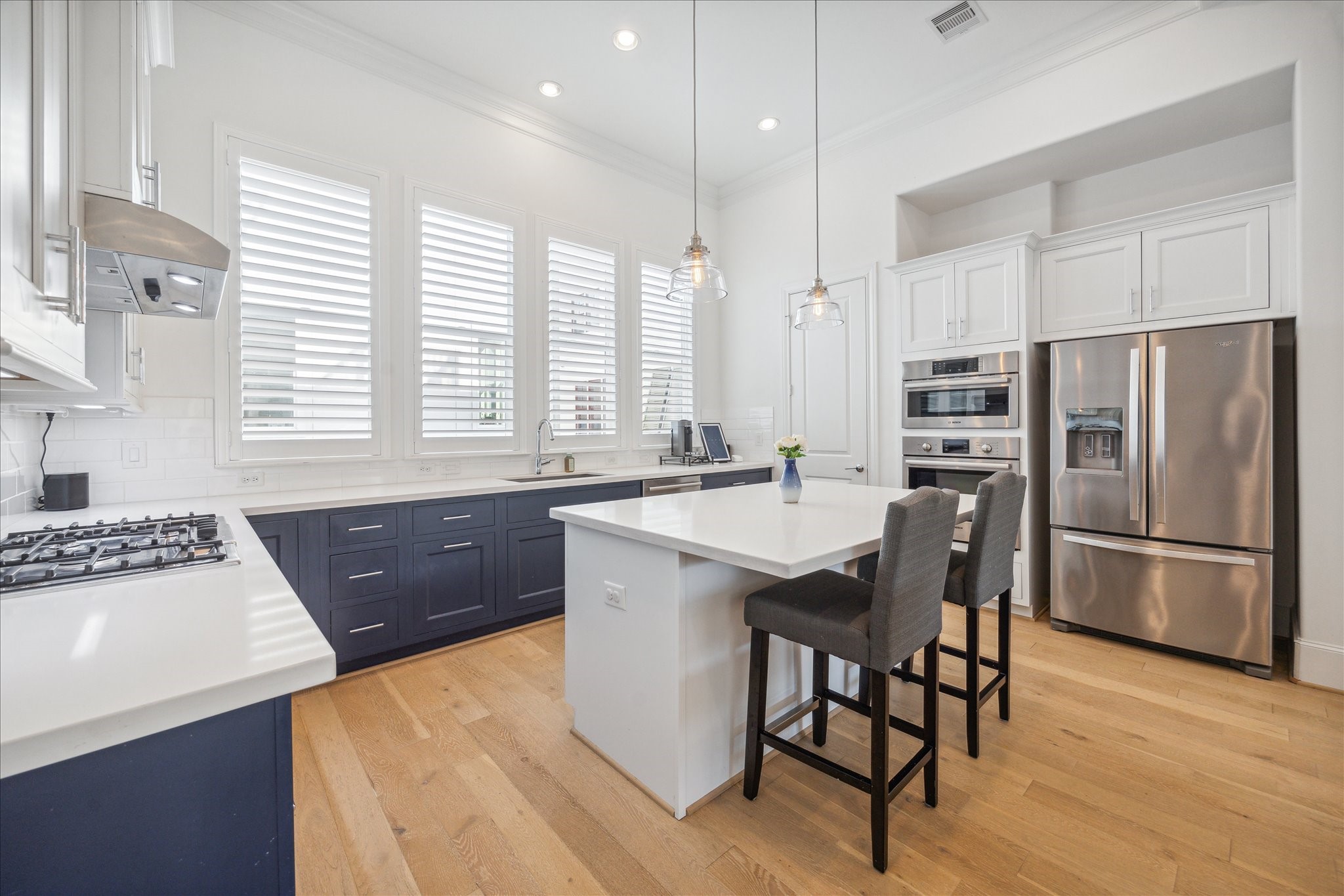2714 Harvard Street Houston, TX 77008 - Photo 3 of 32 a kitchen with a stove a sink a refrigerator a dining table and chairs