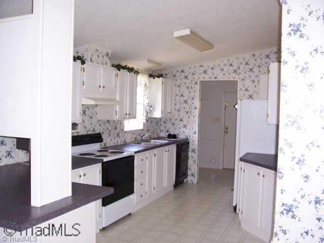 4104 Dodgetown Road Walnut Cove, NC 27052 - Photo 2 of 8 Other. Bright white kitchen with tons of cabinet space plus walk in pantry.