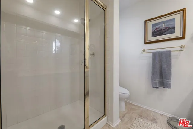 a bathroom with a shower and a sink