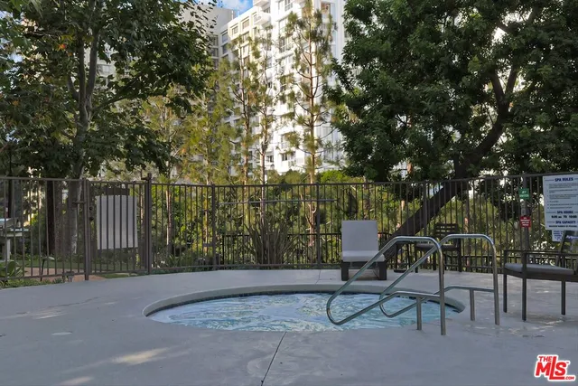 a view of backyard with table and chairs and wooden fence