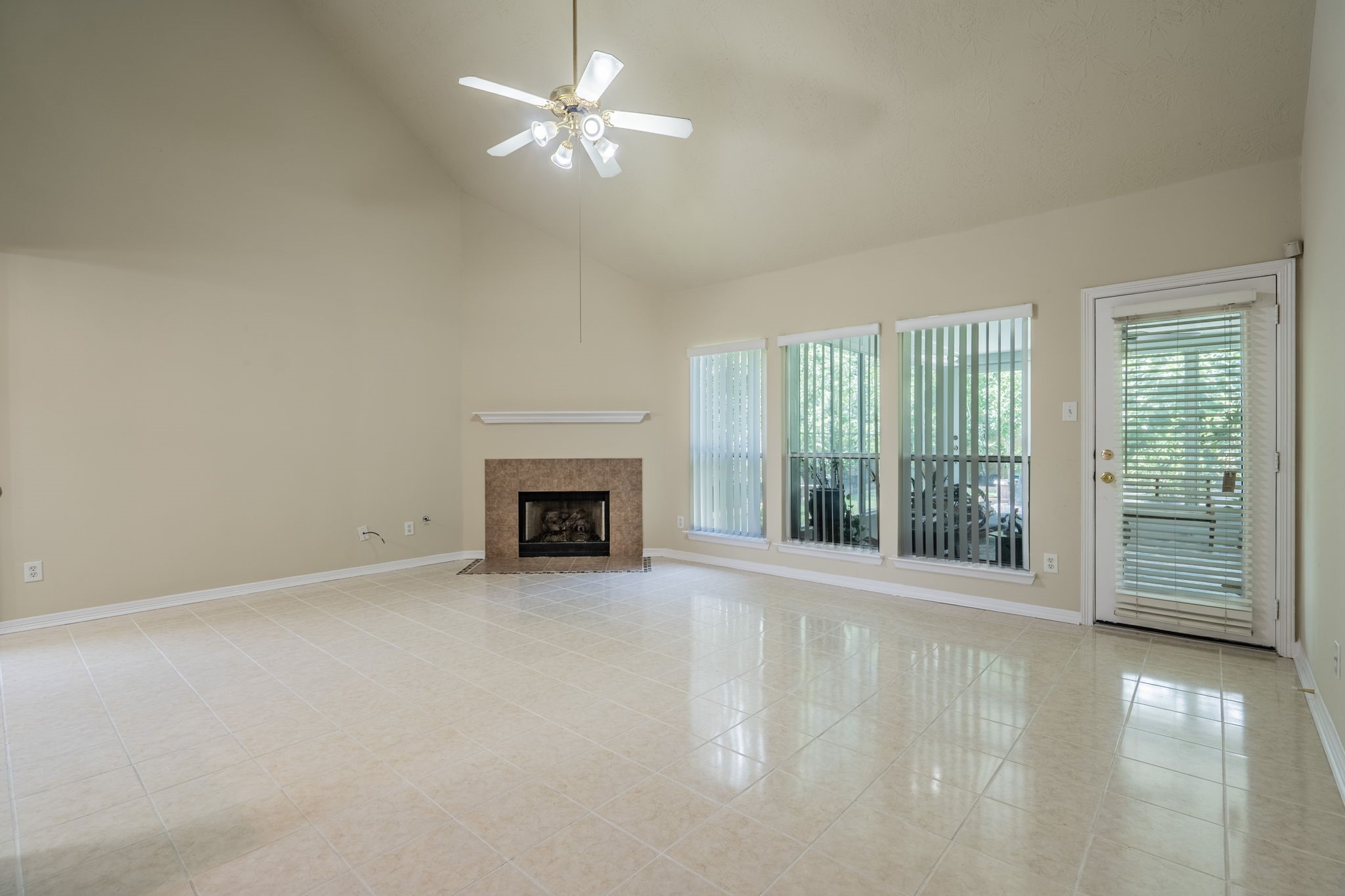 24139 Spring Sunset Drive Spring, TX 77373 - Photo 4 of 26 an empty room with fireplace fan and windows