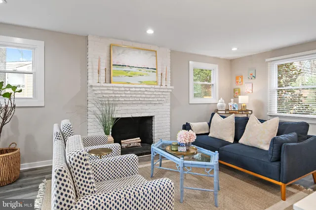 a kitchen with stainless steel appliances kitchen island granite countertop a dining table chairs and white cabinets