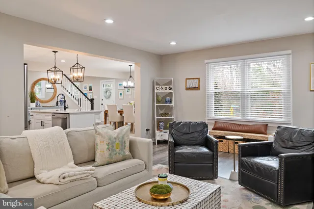 a living room with furniture a rug and a flat screen tv
