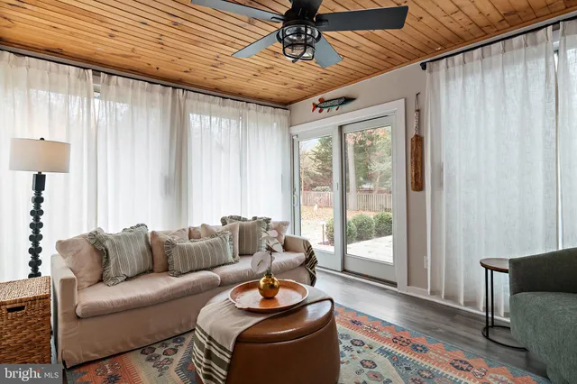 a living room with furniture a flat screen tv and a lamp