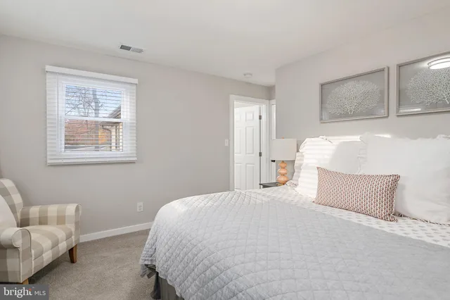a view of a chair and table in backyard of the house