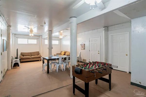 a dining room with furniture and a chandelier