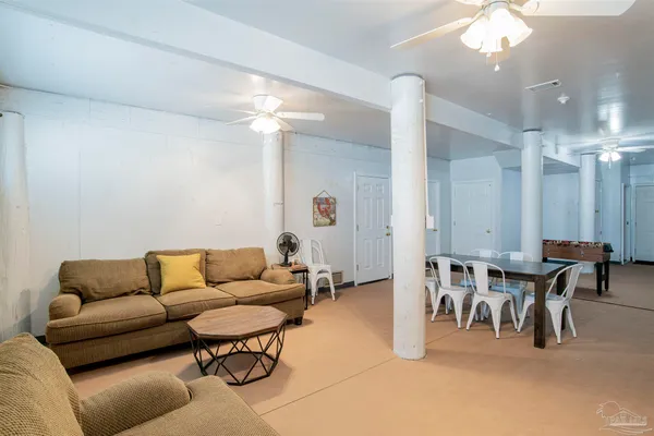 a living room with furniture a dining table and chairs