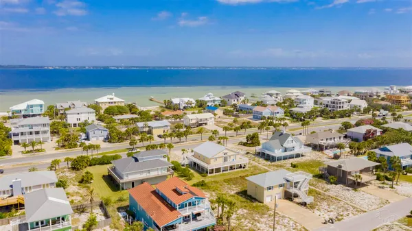 an aerial view of residential building and ocean