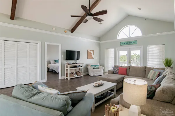 a living room with furniture and a flat screen tv