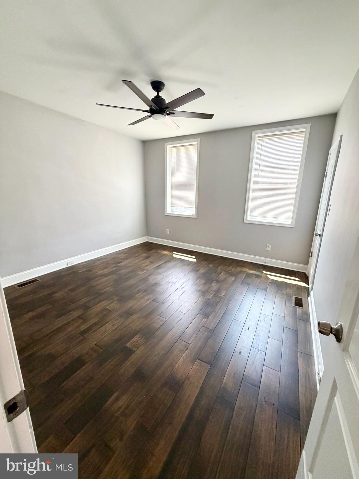 523 Rappolla Street Baltimore, MD 21224 - Photo 5 of 13 a view of an empty room with wooden floor and a window