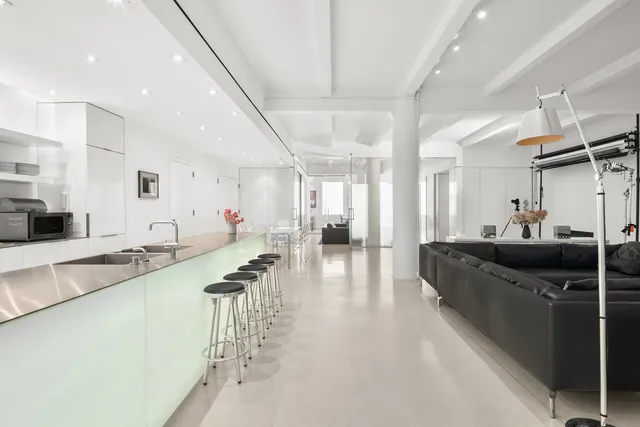 a view of a livingroom with furniture and a ceiling fan