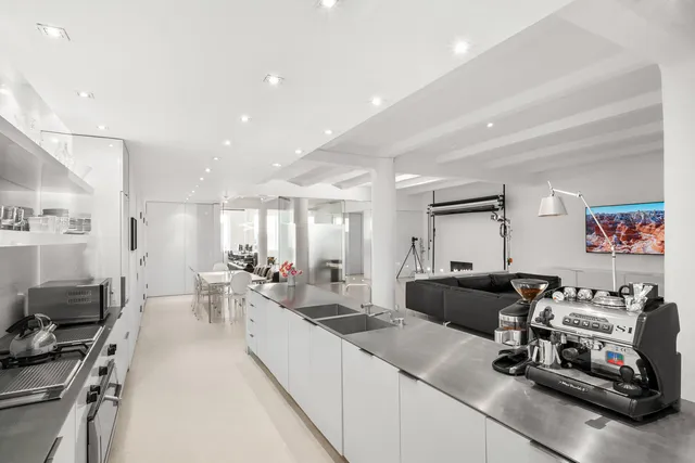 a kitchen with stainless steel appliances a stove a sink and a refrigerator