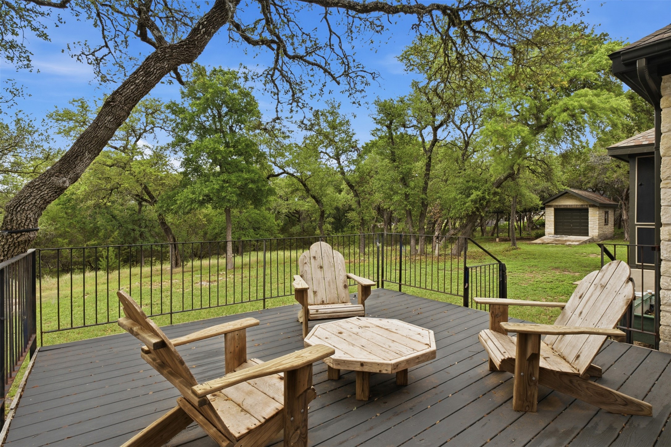 1301 County Road 262 Georgetown, TX 78633 - Photo 34 of 39 Spacious outdoor deck with dark plank flooring and black metal railings