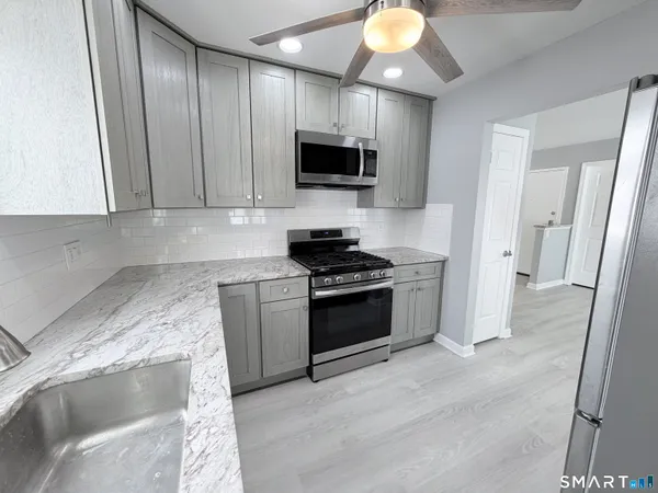 a kitchen with a sink and a stove top oven