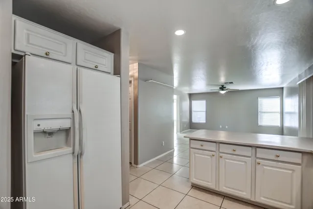 a kitchen with a refrigerator and a sink