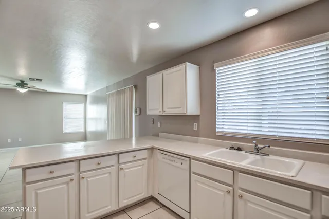 a kitchen with a sink cabinets and window